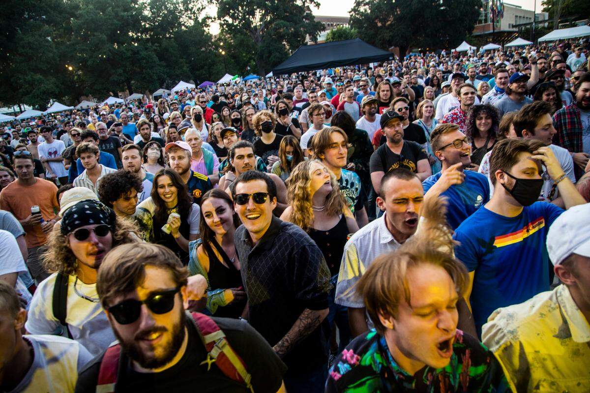 Concert-goers listen to Parquet Courts play Moore Square in Raleigh during the third day of the Hopscotch Music Festival Saturday, Sept. 11, 2021.
