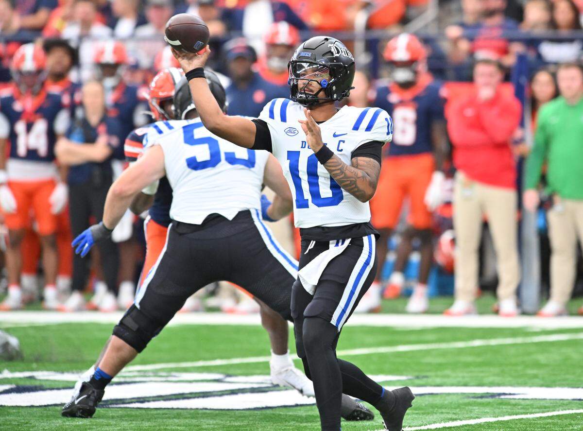 Sep 27, 2025; Syracuse, New York, USA; Duke Blue Devils quarterback Darian Mensah (10) throws a pass against the Syracuse Orange in the first quarter at the JMA Wireless Dome. Mandatory Credit: Mark Konezny-Imagn Images