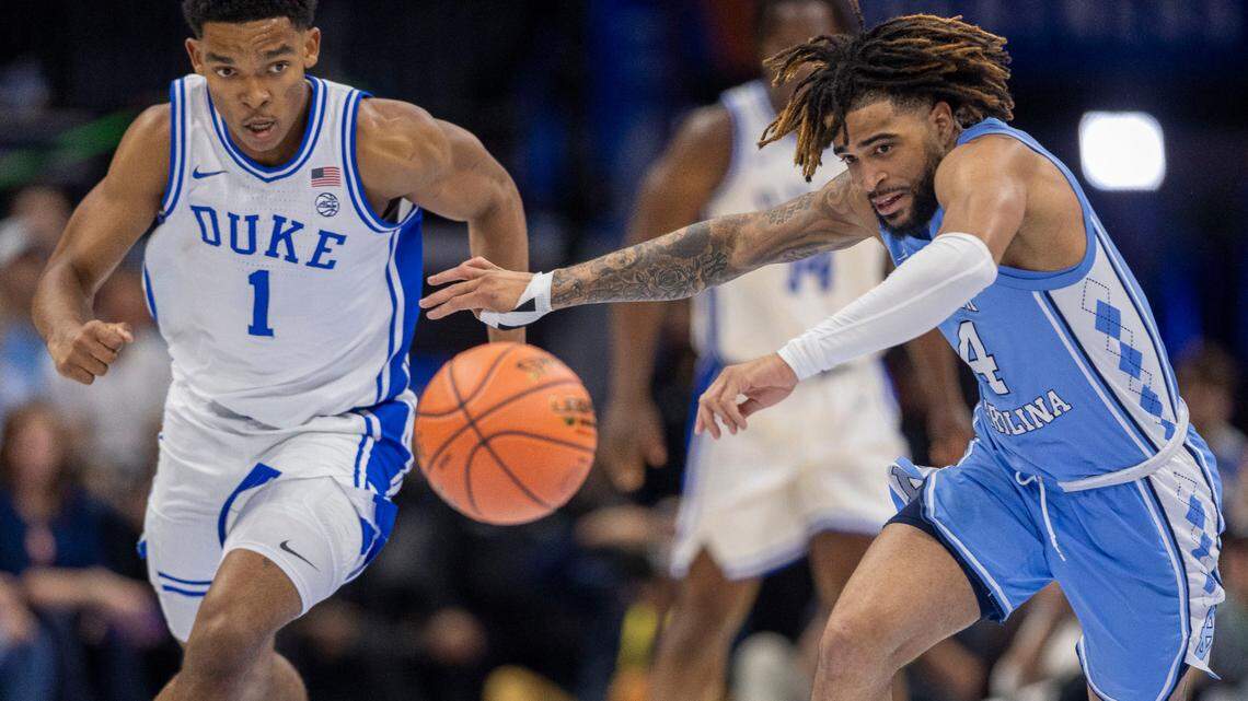Duke’s Caleb Foster (1) forces a turnover by North Carolina guard R.J. Davis (4) in the first half on Friday, March 14, 2025 during the semifinals of the ACC Tournament at Spectrum Center in Charlotte, N.C.