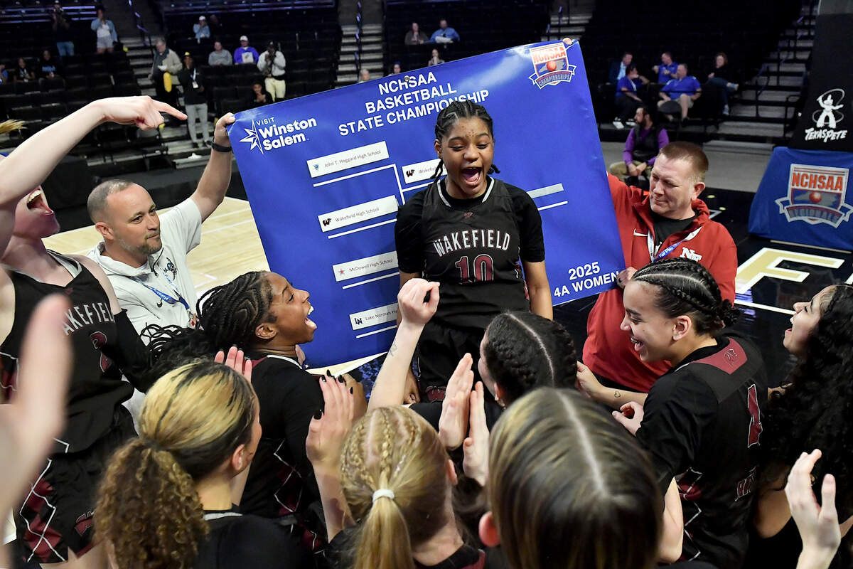 Wakefield’s Jaya Hamilton (10) celebrates with teammates in front of the Championship series bracket after defeating Hoggard 31-23. for the East Regional Title. The Wakefield Wolverines and the Hoggard Vikings met in the NCHSAA 4A East Regional Final in Winston-Salem, N.C. on March 12, 2025.