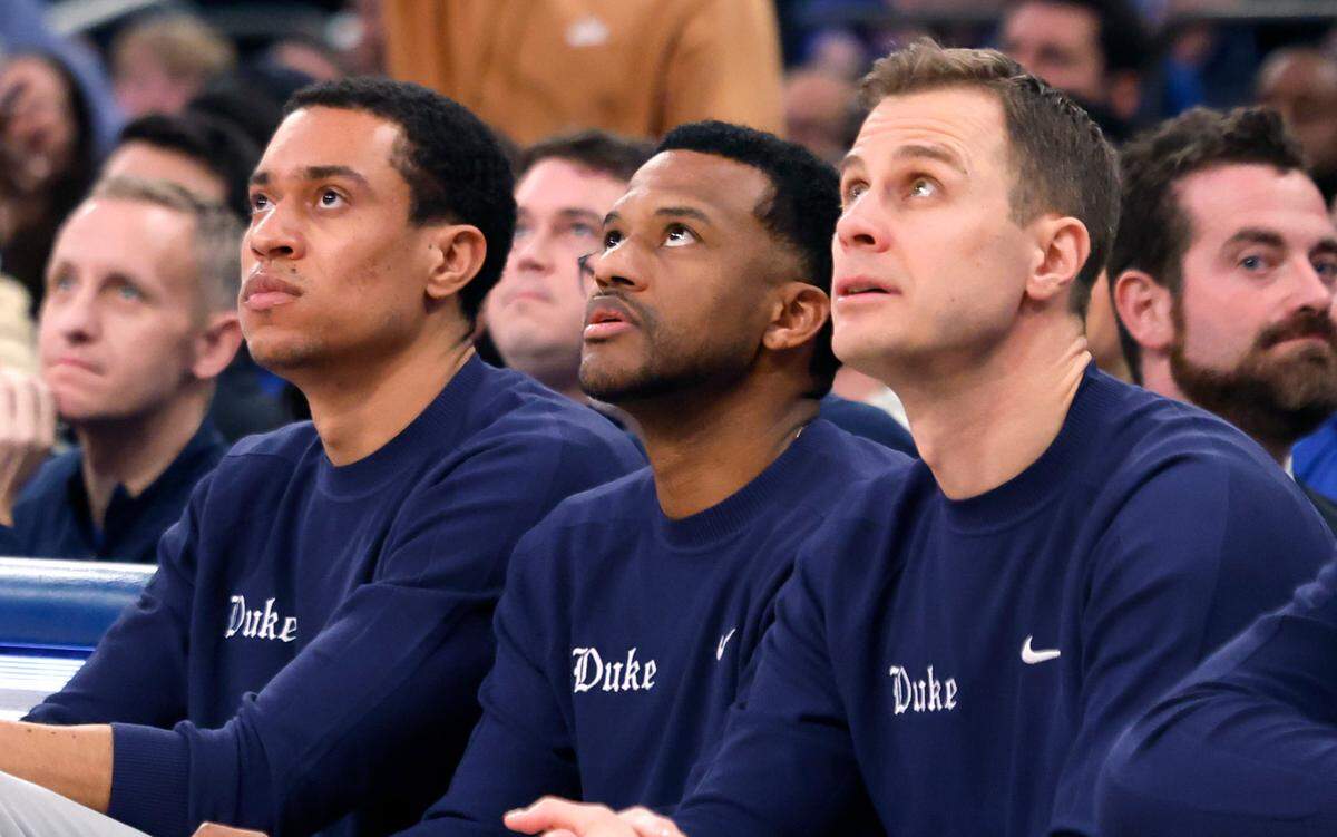 From left, Duke director of player development Justin Robinson, associate head coach Jai Lucas and head coach Jon Scheyer watch to see if the three-pointer by Isaiah Evans falls during the second half of Duke’s 110-67 victory over Illinois in the SentinelOne Classic at Madison Square Garden in New York City Saturday, Feb. 22, 2025.
