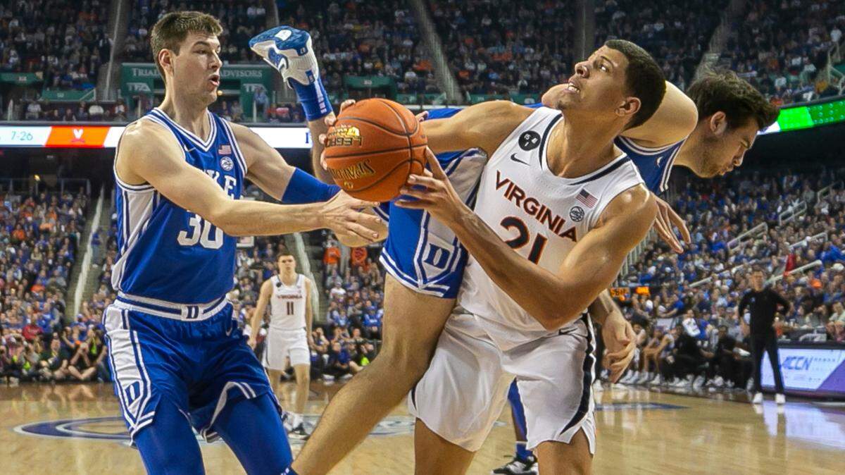 Duke’s Ryan Young (15) collides with Virginia’s Kadin Shedrick (21)during the second half of the championship game of the ACC Tournament on Saturday, March 11, 2023 at the Greensboro Coliseum in Greensboro, N.C.