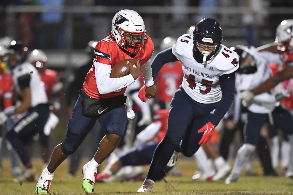 Jordan quarterback Landon Melton (2) runs for yardage against Apex Friendship’s Jack Gentile (45) during the first half. The Apex Friendship Patriots and the Durham Jordan Falcons met in the second round of the NCHSAA 4A playoffs in Durham, N.C. on November 22, 2024.