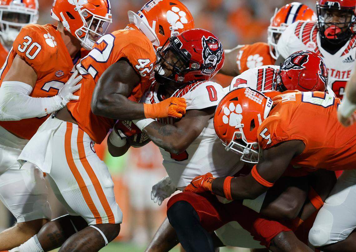 N.C. State running back Demie Sumo-Karngbaye (0) is stopped by Clemson linebacker LaVonta Bentley (42) and defensive end K.J. Henry (5) during the second half of Clemson’s 30-20 victory over N.C. State at Memorial Stadium in Clemson, S.C., Saturday, Oct. 1, 2022.