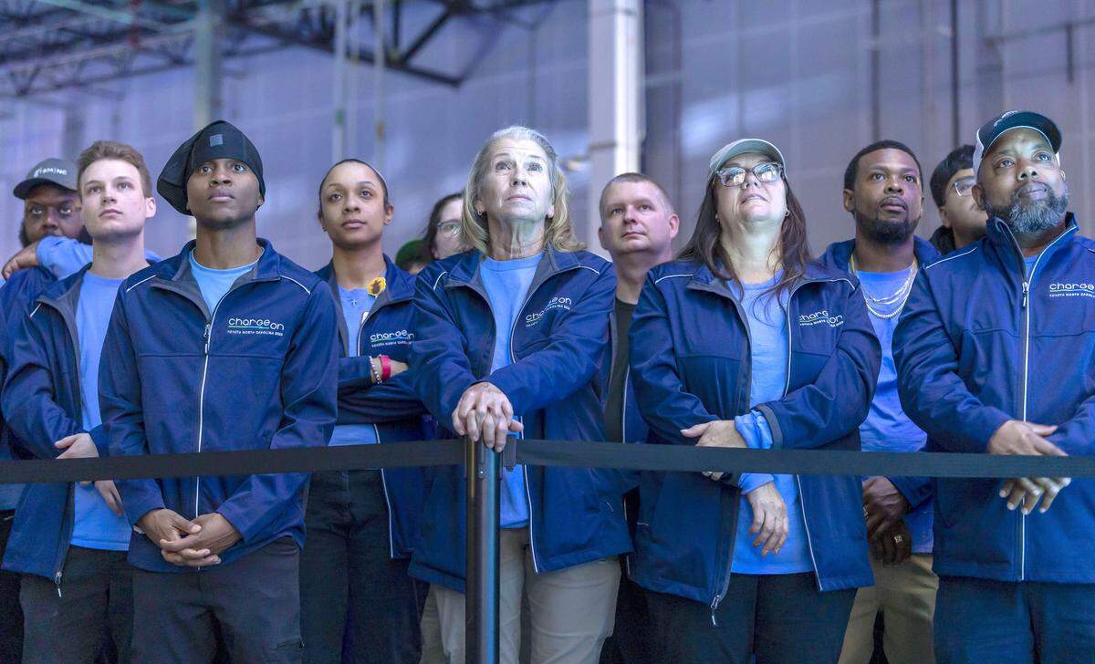 Toyota employees, including Karon Little, center, of Asheboro, N.C., listen to remarks by North Carolina Governor Josh Stein, during the celebration of the production at Toyota’s massive $13.9 billion battery plant in Liberty, N.C. on Wednesday, November 12, 2025.