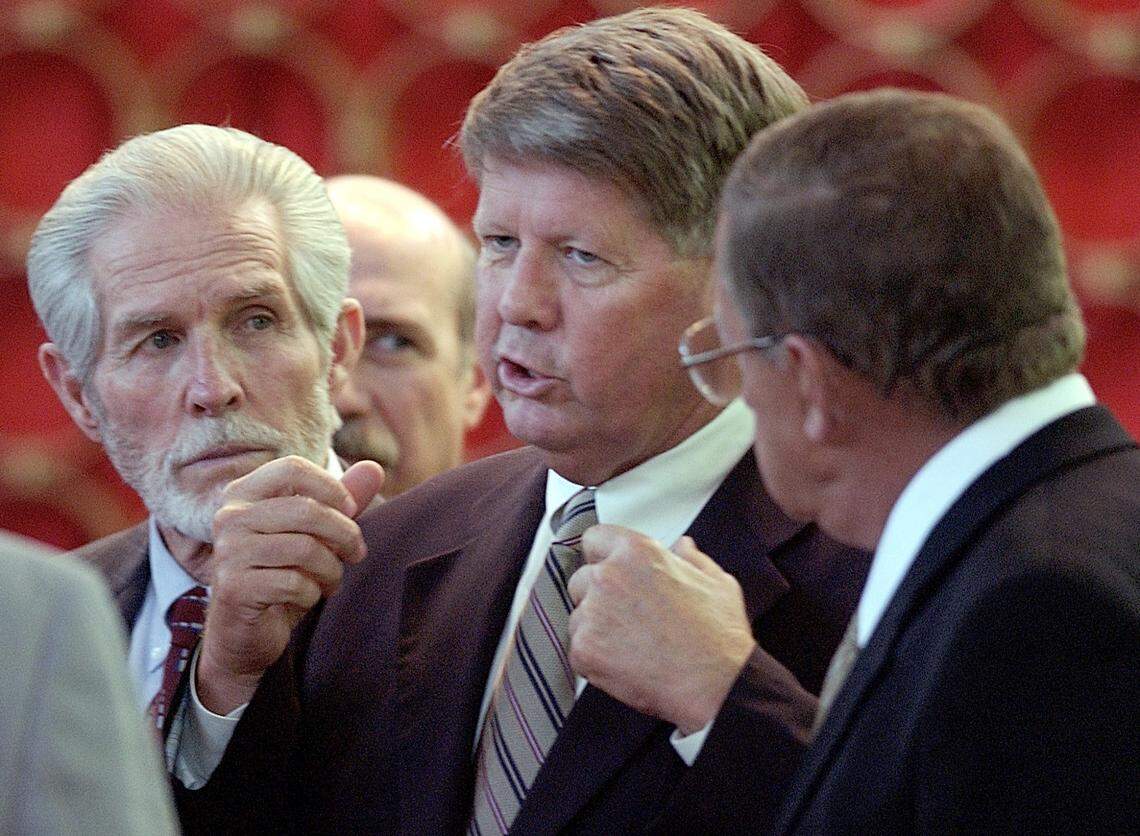 Senator Marc Basnight (center) huddles with Senators Charles Albertson (left) and John Carrington (right) just before the start of a special session of the state Senate at the General Assembly, Tuesday June 11, 2002.