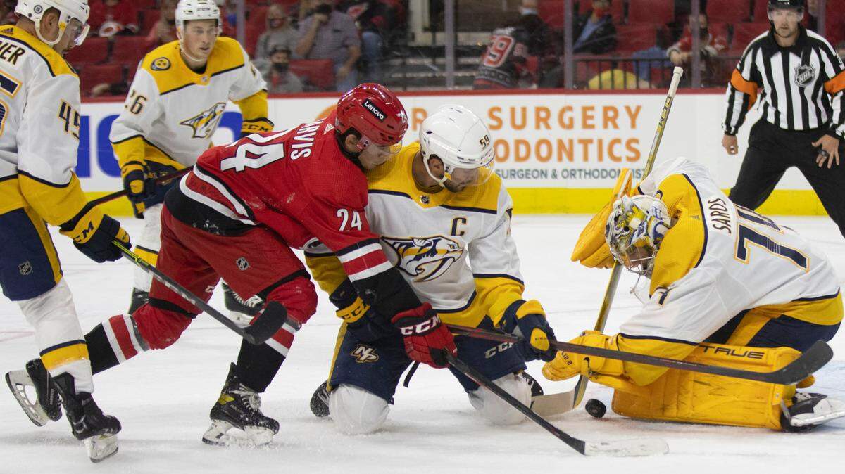 Carolina Hurricanes’ Seth Jarvis (24) tries to score on Nashville goalie Juuse Saros (74) in the first period on Tuesday, October 5, 2021 at PNC Arena in Raleigh, N.C.
