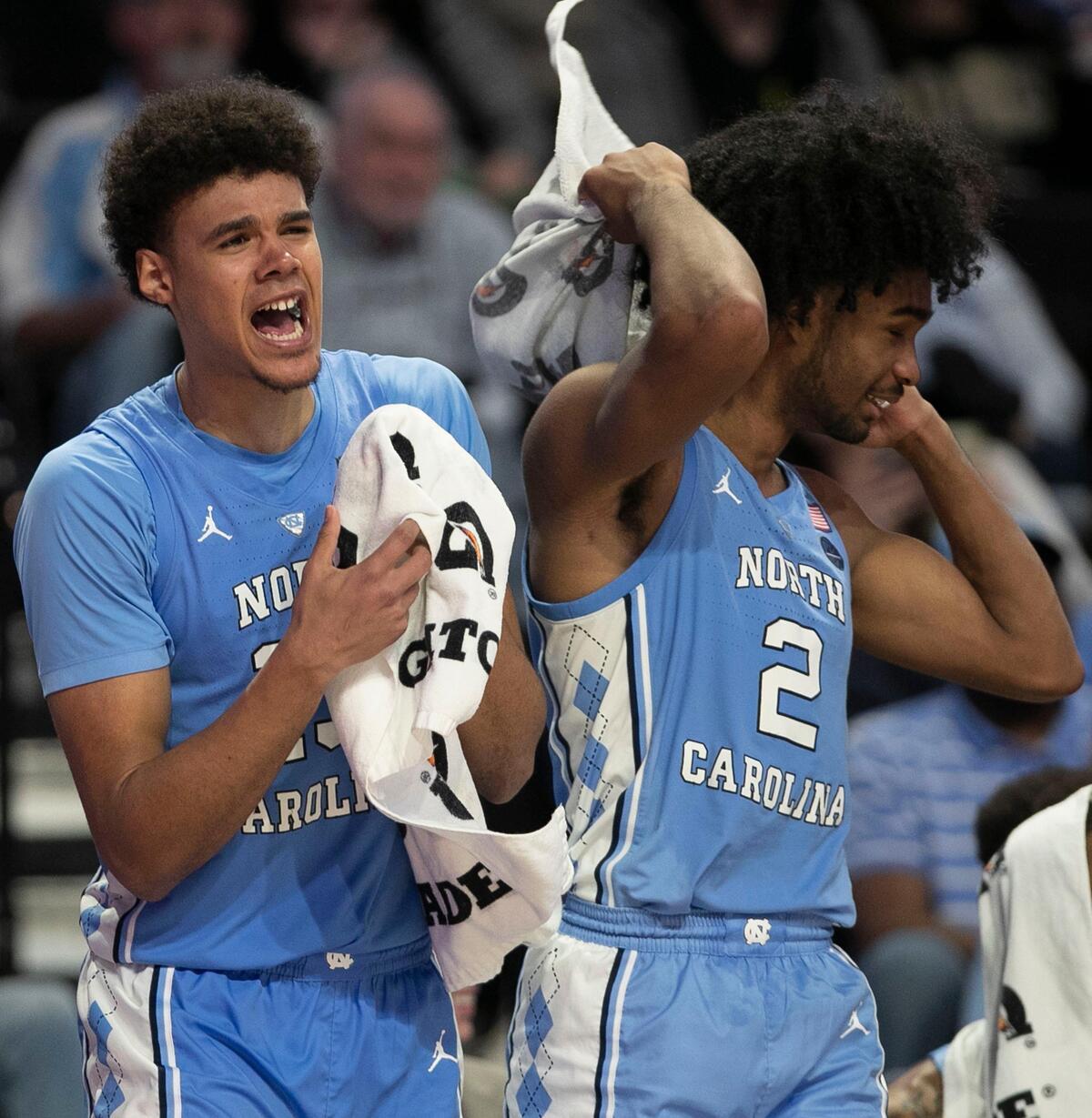 North Carolina’s Cameron Johnson (13) and Coby White (2) cheer on the reserve players during the closing minutes of play against Wake Forest on Saturday, February 16, 2019 at Lawrence Joel Coliseum in Winston-Salem, N.C. Johnson lead all scores with 27 points in the Tar Heels’ 95-57 victory.