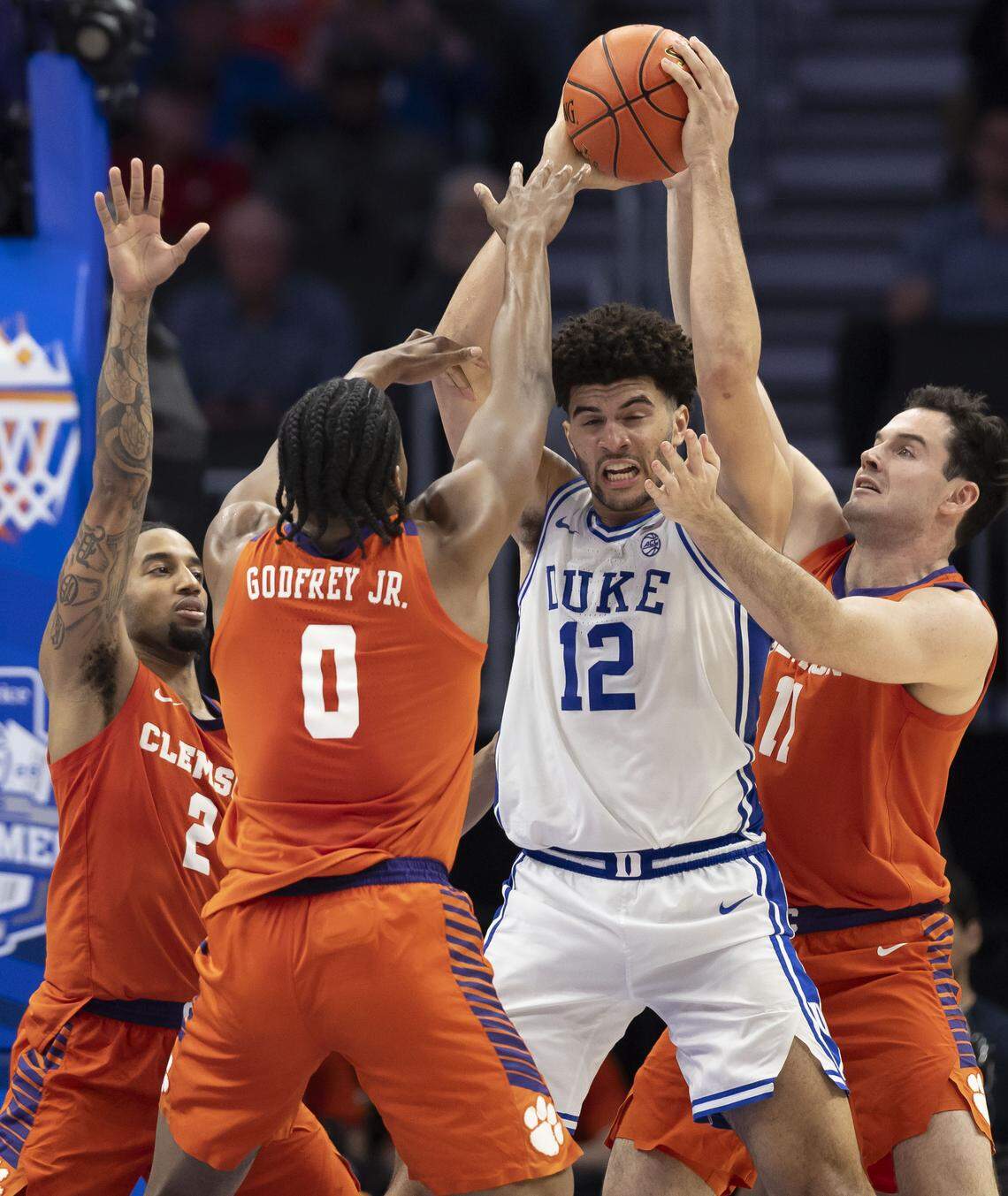 Clemson guard Dillon Hunter (2) and forwards R J Godfrey (0) and Nick Davidson (11) trap Duke forward Cameron Boozer (12) in the second half on Friday, March 13, 2026, during the semifinals of the ACC Tournament at Spectrum Center in Charlotte, N.C. Cameron Boozer lead all scores with 24 points in the Blue Devils’  73-61 victory. 