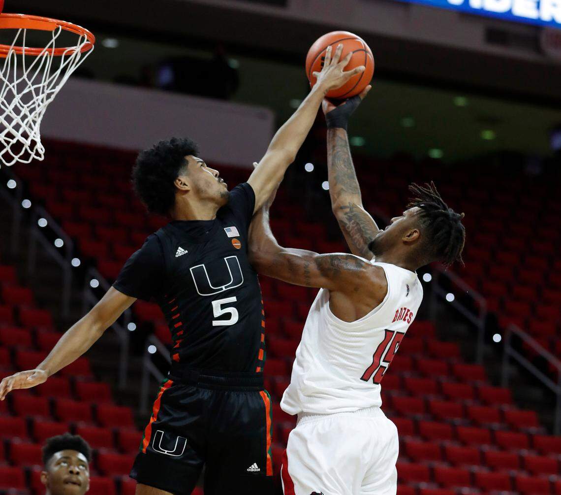 Miami’s Harlond Beverly (5) blocks the shot by N.C. State’s Manny Bates (15) during the first half of N.C. State’s game against Miami at PNC Arena in Raleigh, N.C., Saturday, January 9, 2021.