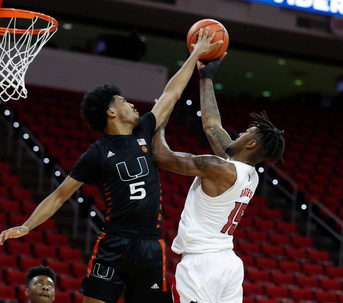 Miami’s Harlond Beverly (5) blocks the shot by N.C. State’s Manny Bates (15) during the first half of N.C. State’s game against Miami at PNC Arena in Raleigh, N.C., Saturday, January 9, 2021.