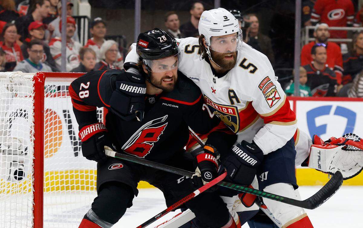 Carolina’s William Carrier (28) battles for position with Panthers’ Aaron Ekblad (5) during the first period of the Carolina Hurricanes’ game against the Florida Panthers in Game 2 of the Eastern Conference Final at the Lenovo Center in Raleigh, N.C., Thursday, May 22, 2025.
