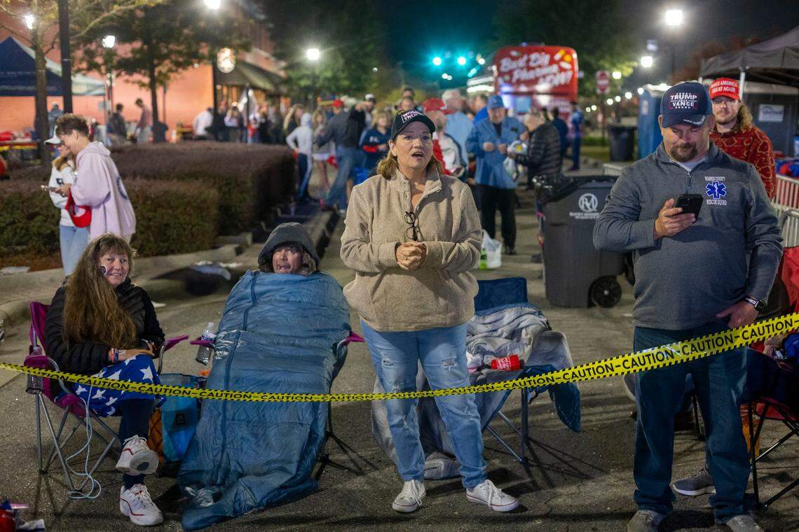Dorothea Ohlandt of Franklinton, left, Karen Little, center, of Rocky Mount, and Donald Duke, right of Henderson were among the first in line to enter a rally for Republican presidential nominee former President Donald Trump on Wednesday, October 30, 2024 at the Rocky Mount Event Center in Rocky Mount, N.C. This group all arrived well before midnight Tuesday to stake out their spots in line.
