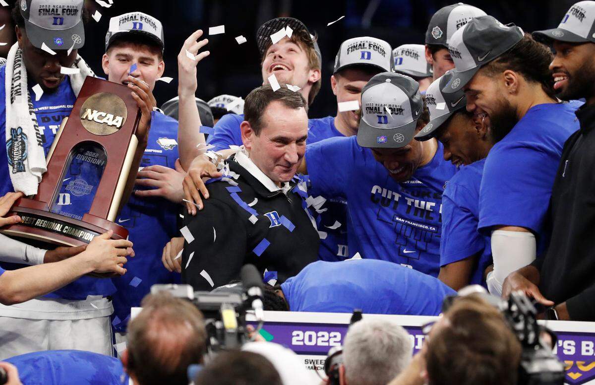 Duke’s Wendell Moore Jr. hugs coach Mike Krzyzewski after Duke’s 78-69 victory over Arkansas in the NCAA Tournament West Regional finals at the Chase Center in San Francisco, Calif., Saturday, March 26, 2022.