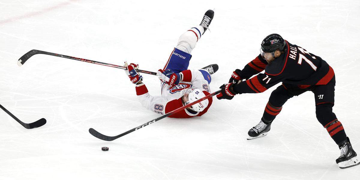 Carolina's Taylor Hall (71) takes the puck from Montréal's Alexandre Texier (85) in the second period of the Hurricanes’ game against the Canadiens in game two of the Eastern Conference Finals at the Lenovo Center in Raleigh, N.C., Saturday, May 23, 2026.