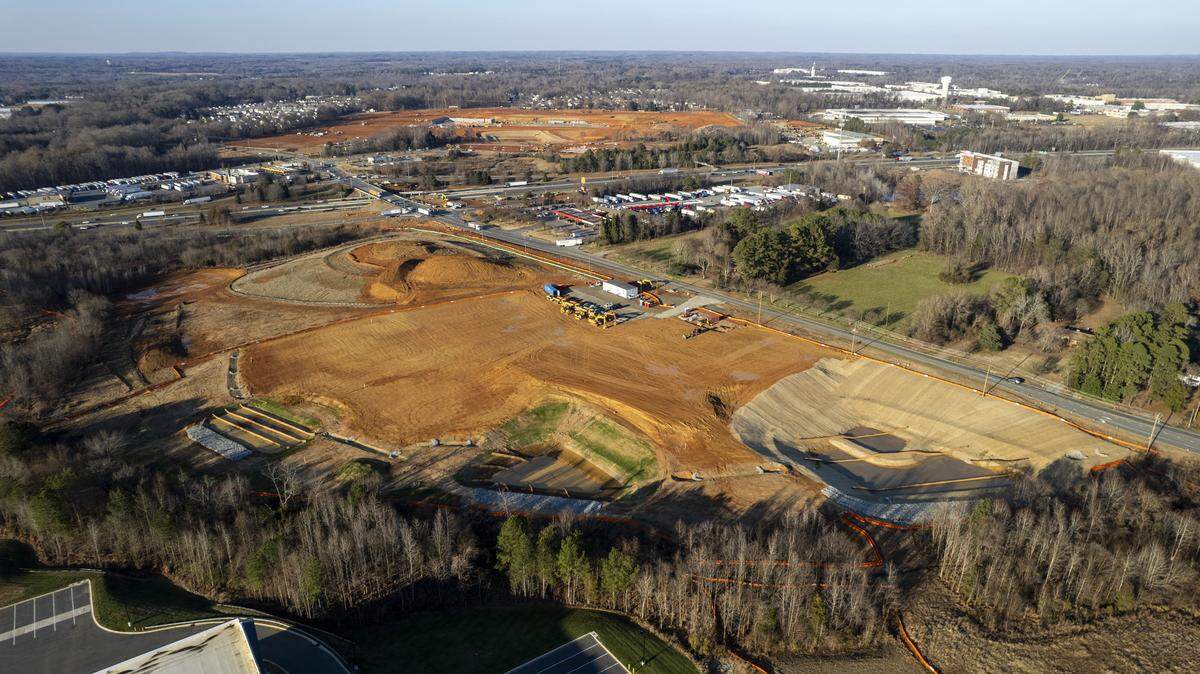 A December 2025 aerial view of the 32-acre site off Interstate 40/85 in Alamance County that will be the state’s first Buc-ee’s travel center, set to open by 2027. Koury Corp.’s Third & Wood development is shown in the distance.