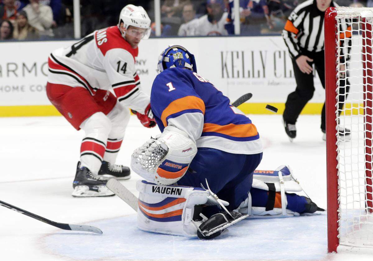 Carolina Hurricanes’ Justin Williams (14) shoots the puck past New York Islanders goaltender Thomas Greiss (1) for a goal during the third period of an NHL hockey game Tuesday, Jan. 8, 2019, in New York. The Hurricanes won 4-3. (AP Photo/Frank Franklin II)