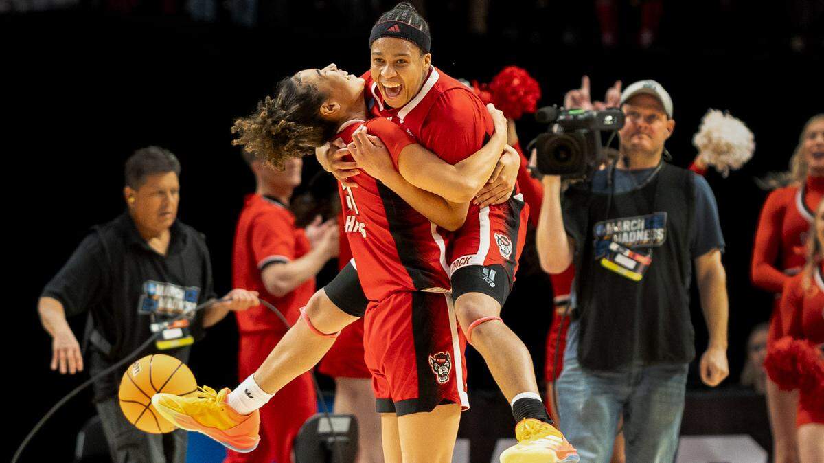 NC State’s Zoe Brooks leaps into the arms of Madison Hayes as the Wolfpack defeats in the NCAA Sweet 16 in Portland.