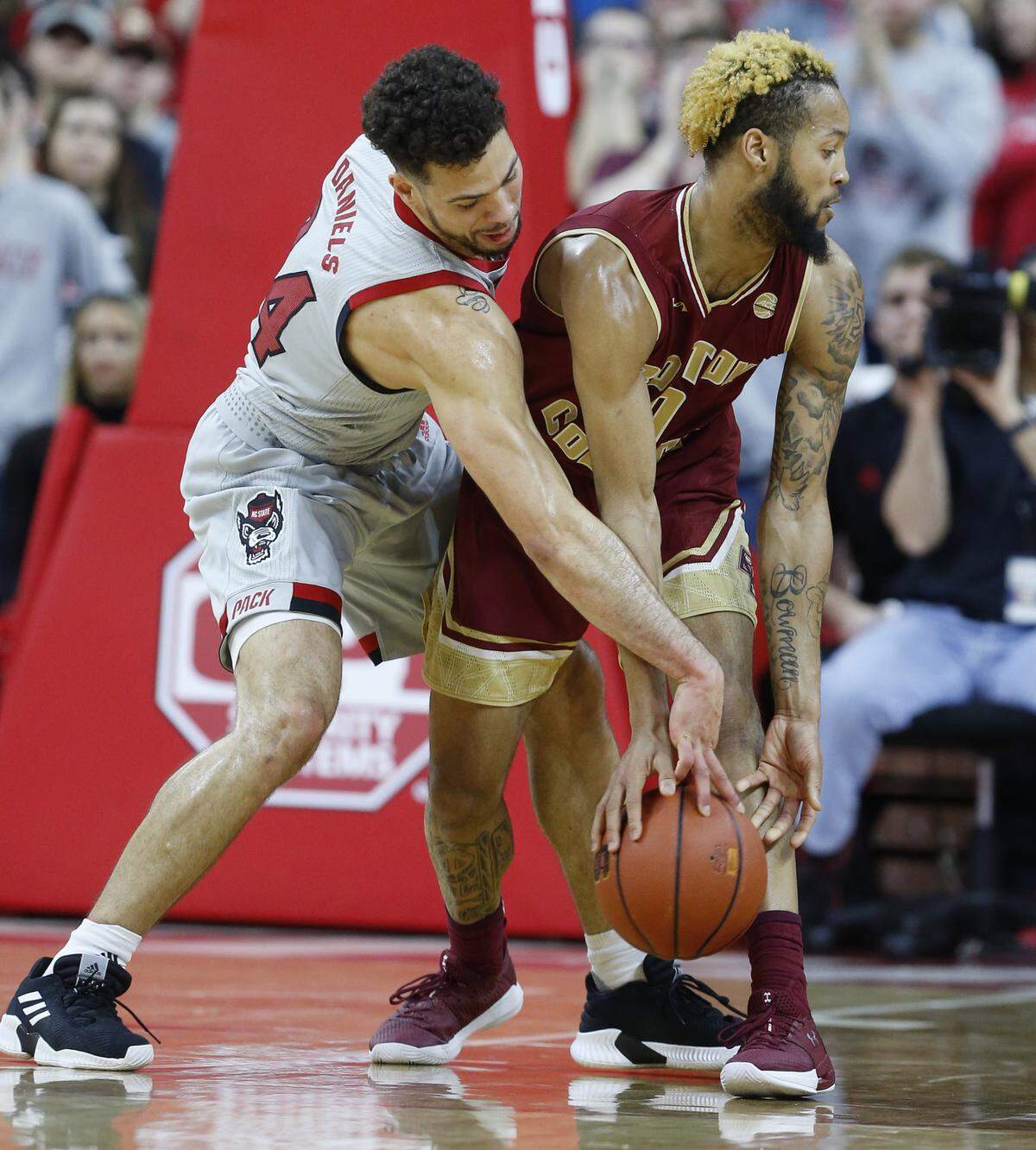 N.C. State’s Devon Daniels (24) knocks the ball free from Boston College’s Ky Bowman (0) during the first half of N.C. State’s game against Boston College at PNC Arena in Raleigh, N.C., Wednesday, Feb. 20, 2019.