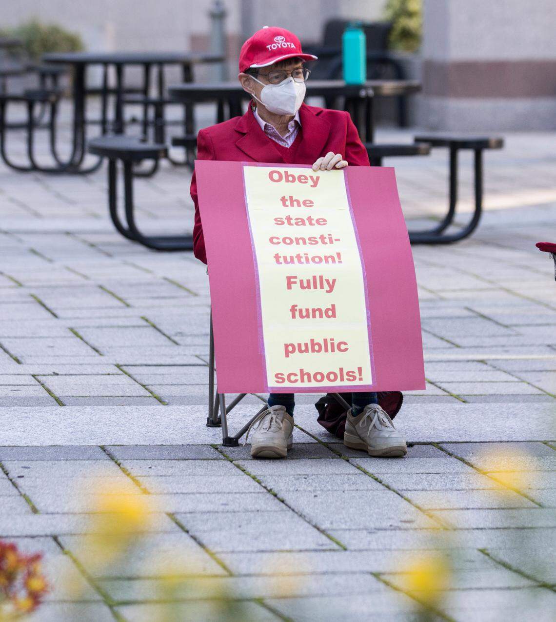 Patricia Long awaits the start of a prayer vigil urging the N.C. General Assembly to fund the Leandro Plan, in Raleigh, N.C. on Monday, Oct. 18, 2021.