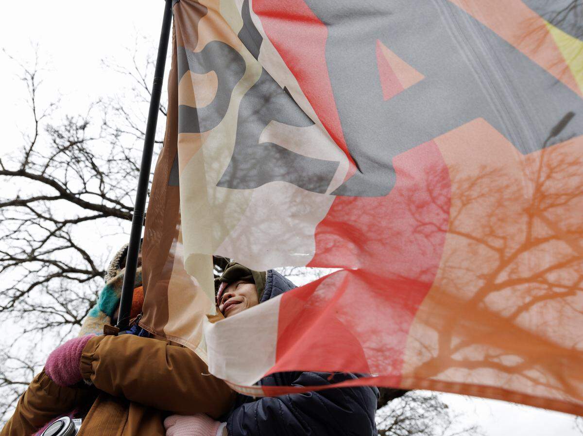 Emily Bernath and Kanjana Pankhum await a procession of Buddhist monks at Dorothea Dix Park as a part of the Walk for Peace on Saturday, Jan. 24, 2026, in Raleigh, N.C.