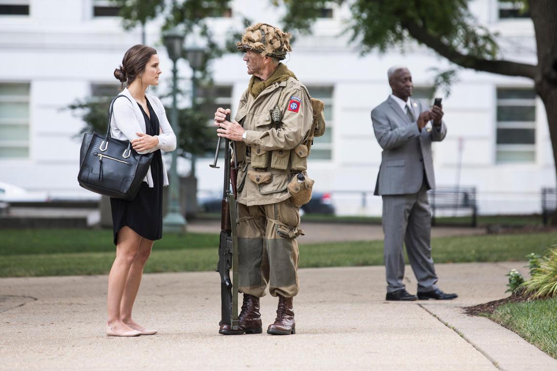 Francis J. Hale III, center, speaks with Grace Irvin, left, outside of the North Carolina State Capitol building before a day of ceremony and recognition for fallen service members on June 6, 2019, the 75th anniversary of D-Day.