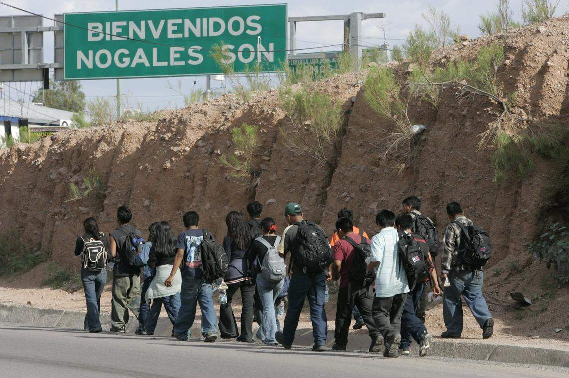 Immigrants who were apprehended along the Border Patrol’s Tucson Sector walk back into Nogales, Arizona, on Monday, July 24, 2006, after being driven in buses back to the border. Many in this group said they would try to cross again.