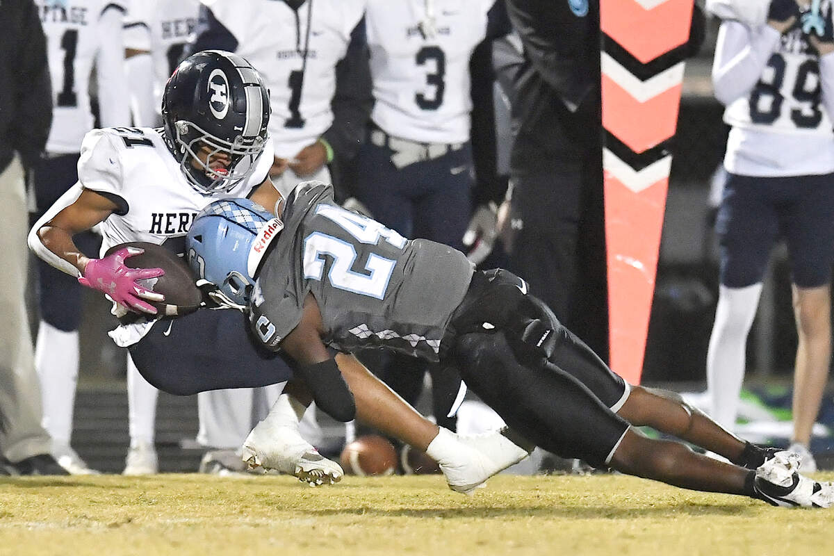 Cleveland defensive back Theron Batiste (24) tackles Heritage’s Jhon Carela-Pantaleon (21) during the first half. The Cleveland Rams and the Heritage Huskies met in the first round of the NCHSAA 4A playoffs in Clayton, N.C. on November 15, 2024.