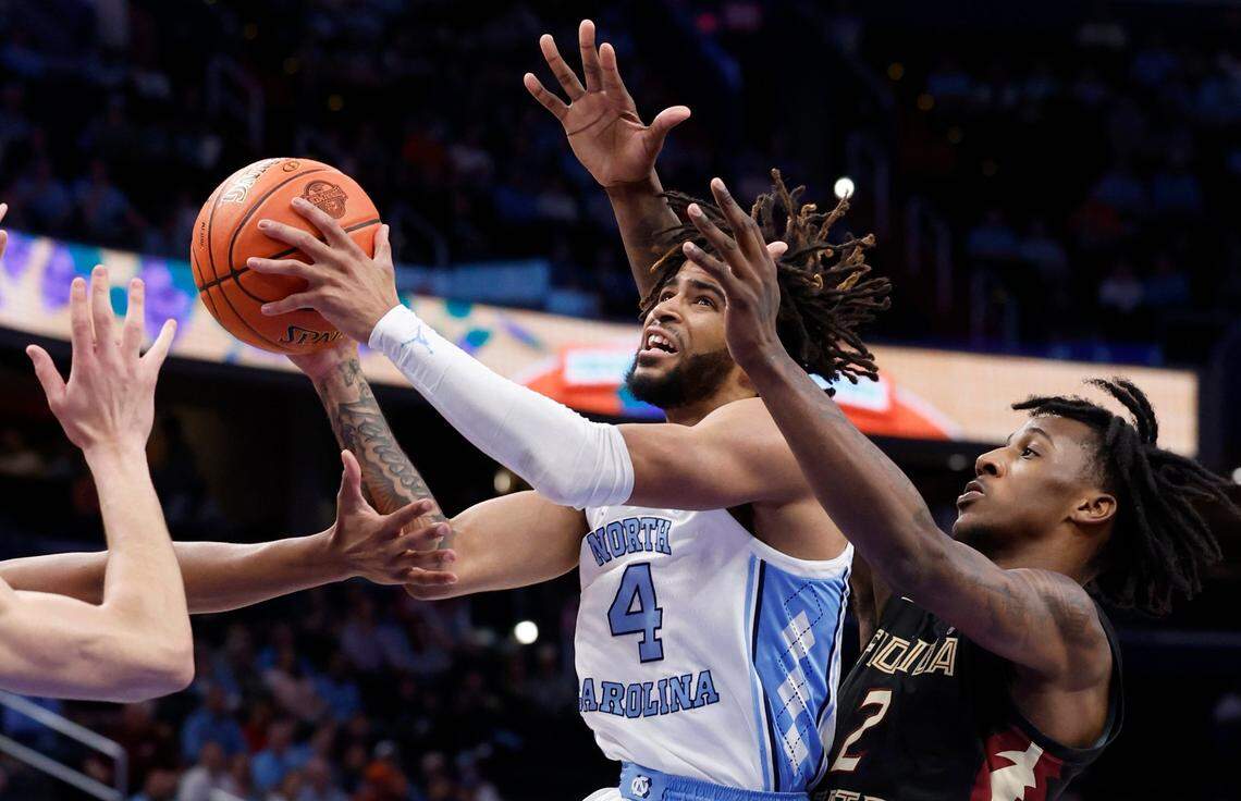 North Carolina’s RJ Davis (4) drives past Florida State’s Jamir Watkins (2) during the first half of UNC’s game against Florida State in the quarterfinal round of the 2024 ACC Men’s Basketball Tournament at Capital One Arena in Washington, D.C., Thursday, March 14, 2024.