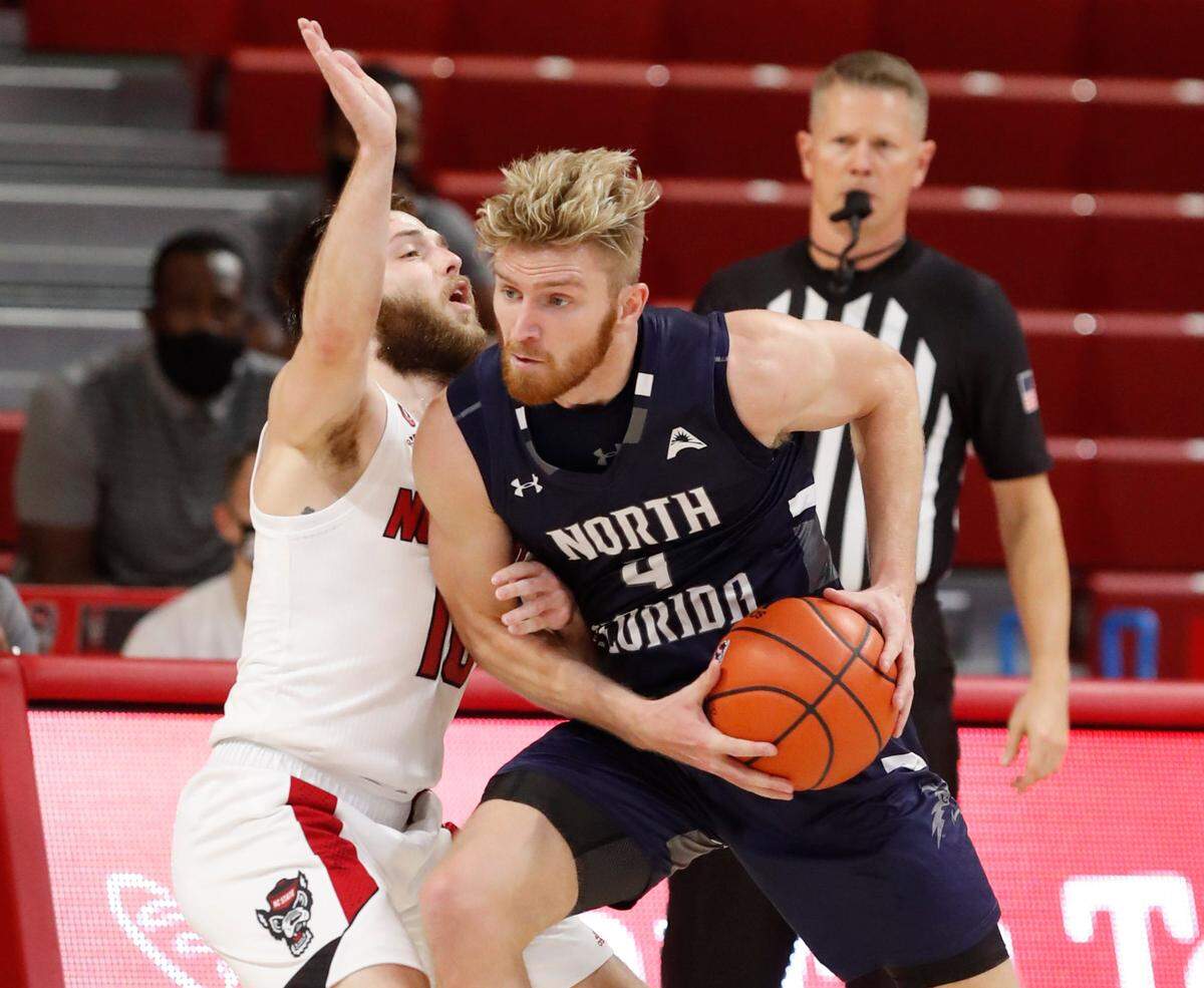 N.C. State’s Braxton Beverly (10) defends North Florida’s Josh Endicott (4) during the first half of N.C. State’s game against North Florida in the Mako Medical Wolfpack Invitational at Reynolds Coliseum in Raleigh, N.C., Friday, Nov. 27, 2020.