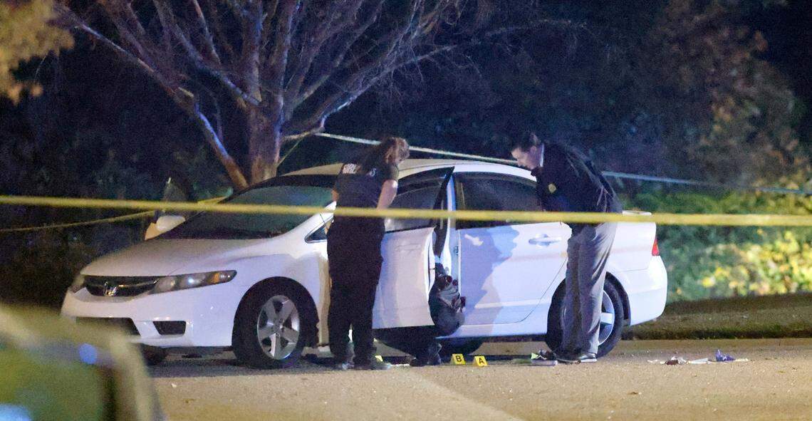 Police work the scene on Osprey Cove Drive in the Hedingham neighborhood in Raleigh, N.C., Thursday evening, Oct. 13, 2022.