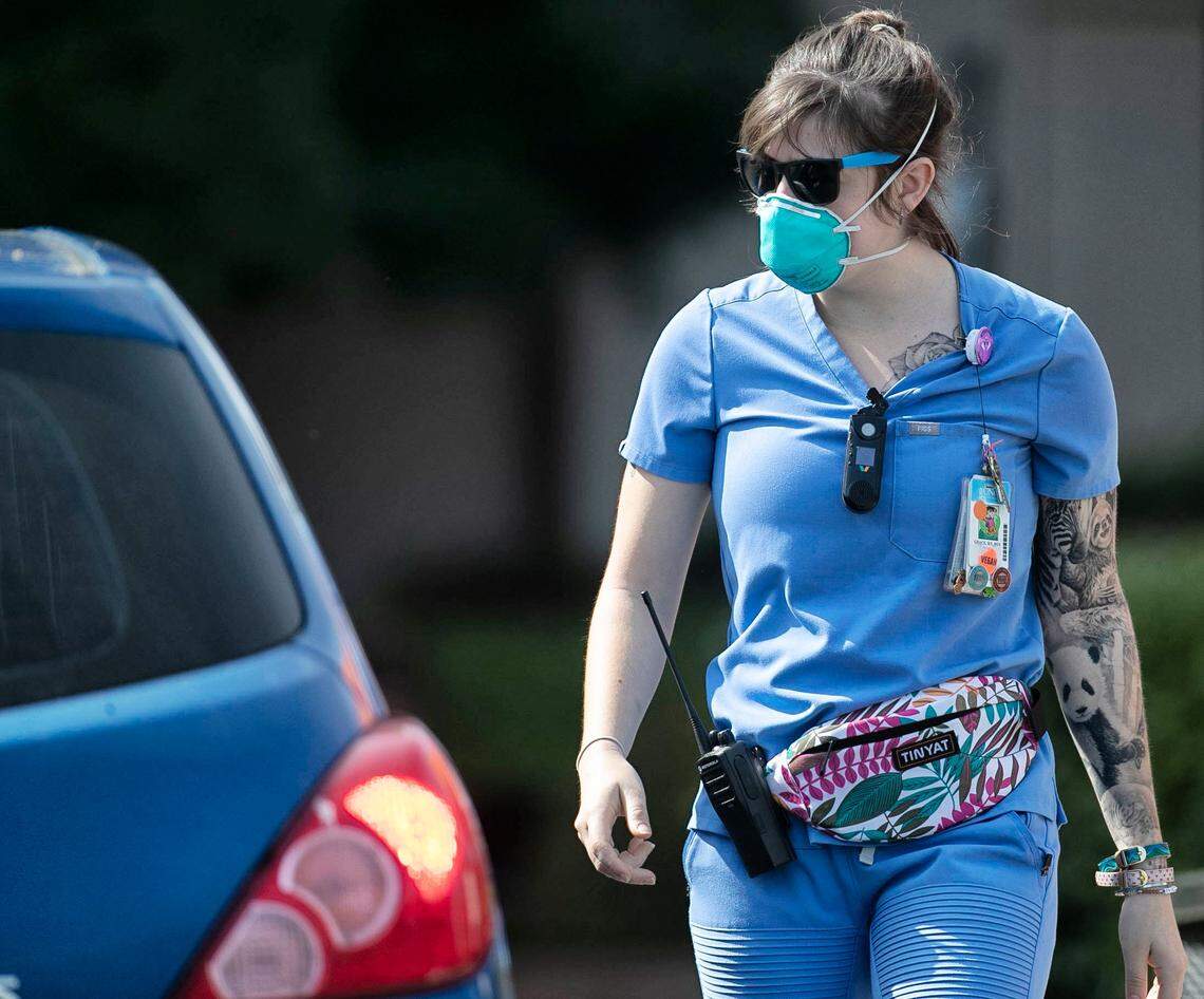 A UNC Hospitals nurse screens visitors to the UNC Medical Center Emergency Department on Monday, March 30, 2020 in Chapel Hill, N.C. These screening procedures started about two weeks ago in an effort to prevent patients with respiratory symptoms of the COVID-19 virus from mixing with other patients in the emergency department. Photo by Robert Willett, The News & Observer #coronavirus #covid19 #chapelhill #unc #unchospital #nurse #hero #rn #photojournalism #readlocal