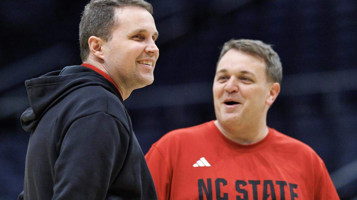 N.C. State head coach Will Wade smiles as he stands with assistant coach Adam Howard during practice at University of Dayton Arena in Dayton, Ohio on Monday, March 16, 2026. The Wolfpack will face Texas in the First Four on Tuesday.