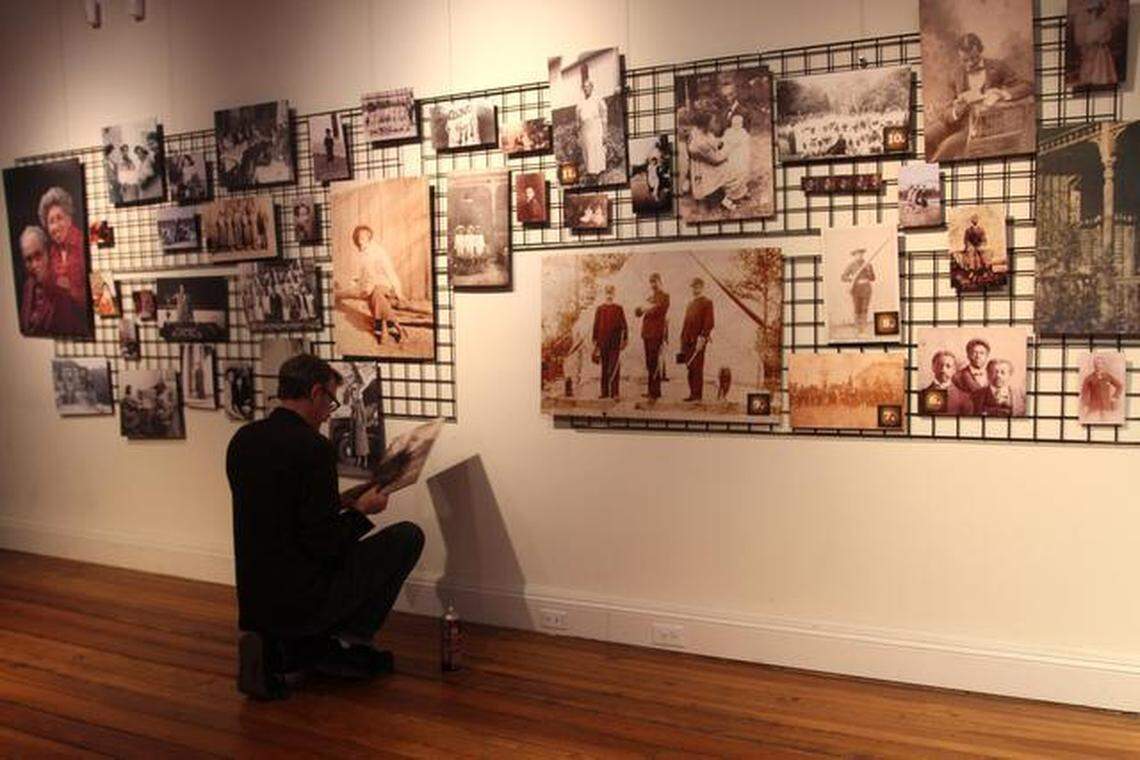 Ernest Dollar, director of the City of Raleigh Museum, puts the finishing touches on “A Family Story: Photographs from the Pope House,” an exhibit in honor of Black History Month.