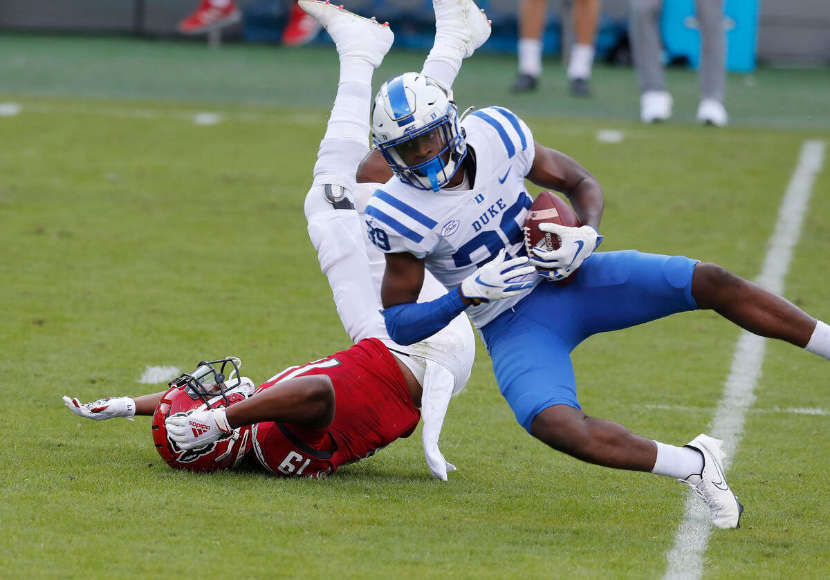 Duke cornerback Jeremiah Lewis (39) intercepts the ball intended for N.C. State wide receiver C.J. Riley (19) during the first half of N.C. State’s game against Duke at Carter-Finley Stadium in Raleigh, N.C., Saturday, Oct. 17, 2020.