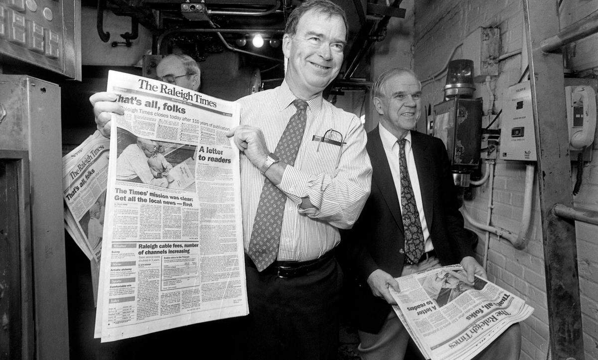 Publisher Frank Daniels Jr.and Raleigh Times Editor AC Snow look over the final edition of the Raleigh Times as it rolls off the presses on November 30, 1989 in Raleigh, N.C.