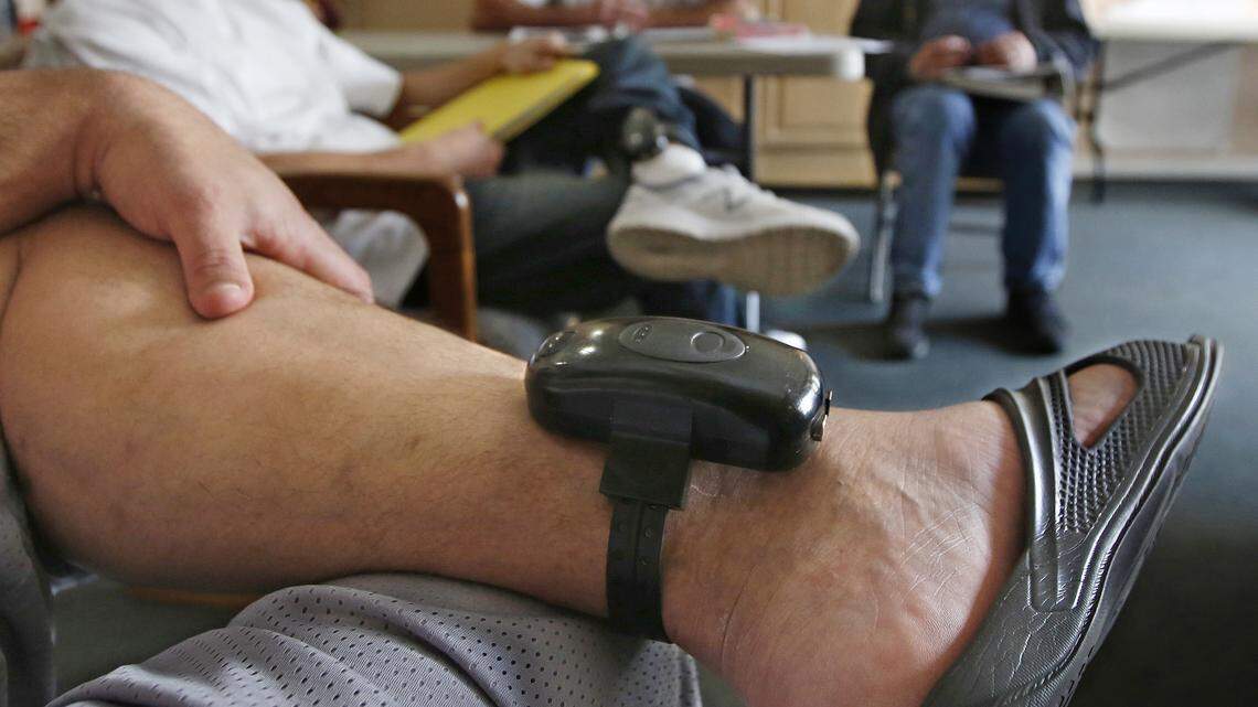 A GPS bracelet is seen on the ankle of an inmate attending a discussion about living in sobriety at the Male Community Re-entry Program in Oroville, Calif. California’s attempt to ease prison inmates transition back into the community is coming at a price, as an increasing number of prisoners simply walk away. Facilities like the one in Butte County, and in similar programs elsewhere are lightly guarded and inmates wear GPS bracelets that show their locations.