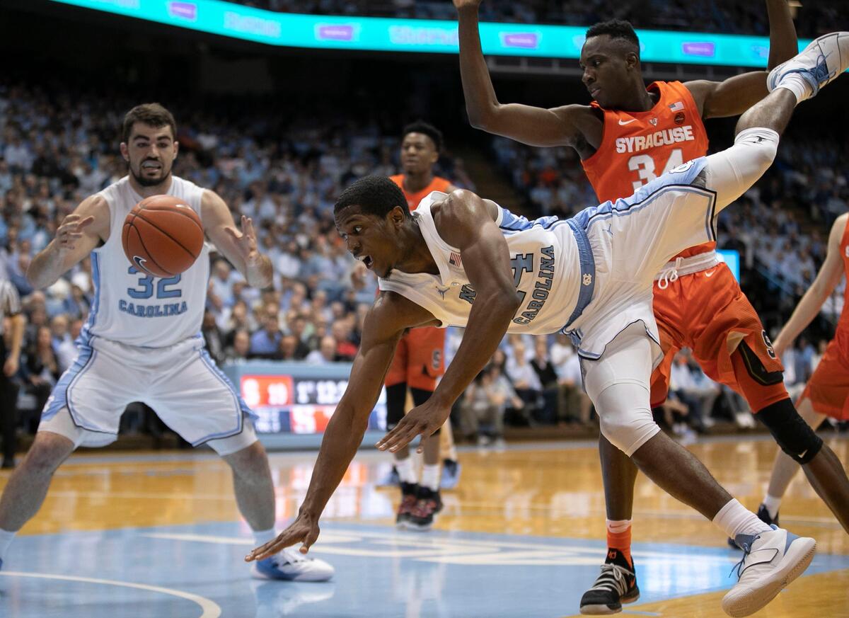 North Carolina’s Kenny Williams (24) slashed through the Syracuse defense and passes to teammate Luke Maye (32) during the first half on Tuesday, February 26, 2019 at the Smith Center in Chapel Hill, N.C.
