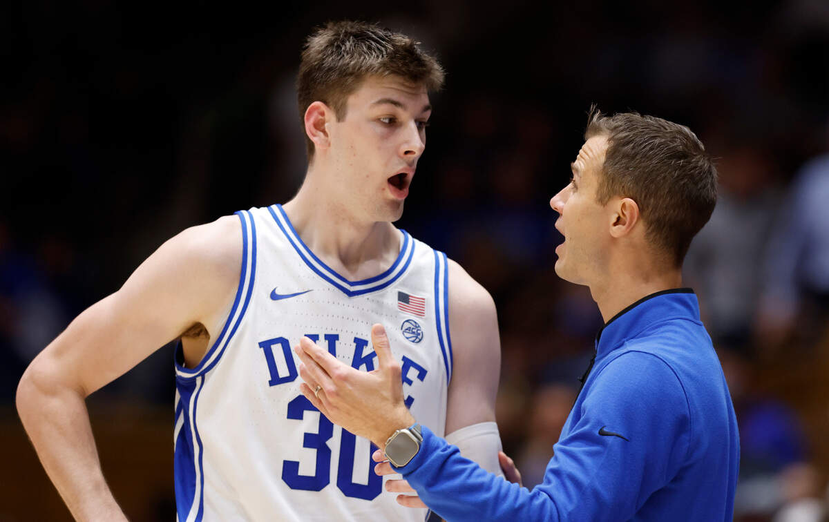 Duke head coach Jon Scheyer talks with Kyle Filipowski (30) during the second half of Duke’s 81-72 victory over Ohio State at Cameron Indoor Stadium in Durham, N.C., Wednesday, Nov. 30, 2022.