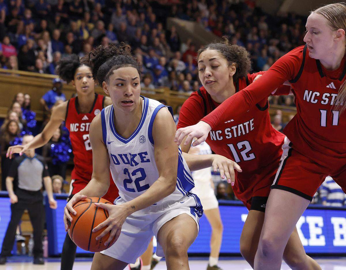 Duke’s Taina Mair drives past N.C. State’s Khamil Pierre and Maddie Cox during the second half of the Blue Devils’ 83-65 win on Thursday, Feb. 19, 2026, at Cameron Indoor Stadium in Durham, N.C. 