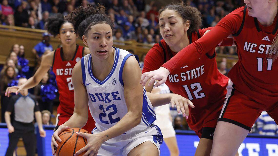 Duke’s Taina Mair drives past N.C. State’s Khamil Pierre and Maddie Cox during the second half of the Blue Devils’ 83-65 win on Thursday, Feb. 19, 2026, at Cameron Indoor Stadium in Durham, N.C.