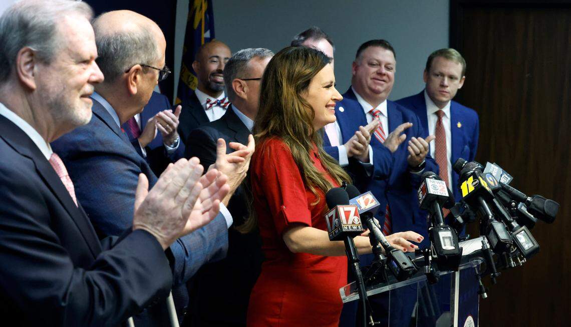 N.C. State Rep. Tricia Cotham, center, is applauded by N.C. House and Senate leaders as she comes to the podium to speak during a press conference at the N.C. GOP headquarters in Raleigh, N.C., Wednesday, April 5, 2023. The press conference was to announce Rep. Cotham is switching parties to become a member of the House Republican caucus.
