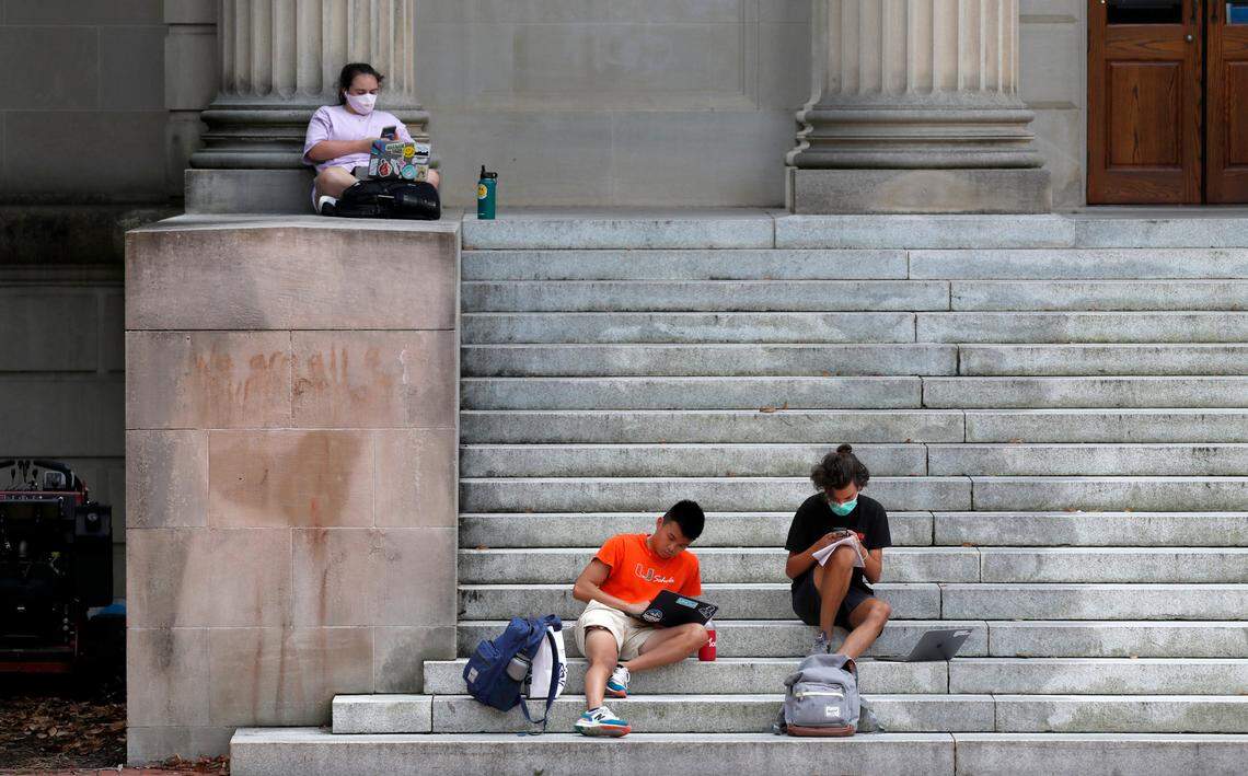 People hang out on the stairs to Wilson Library on the campus of UNC in Chapel Hill, N.C., Tuesday, August 18, 2020.