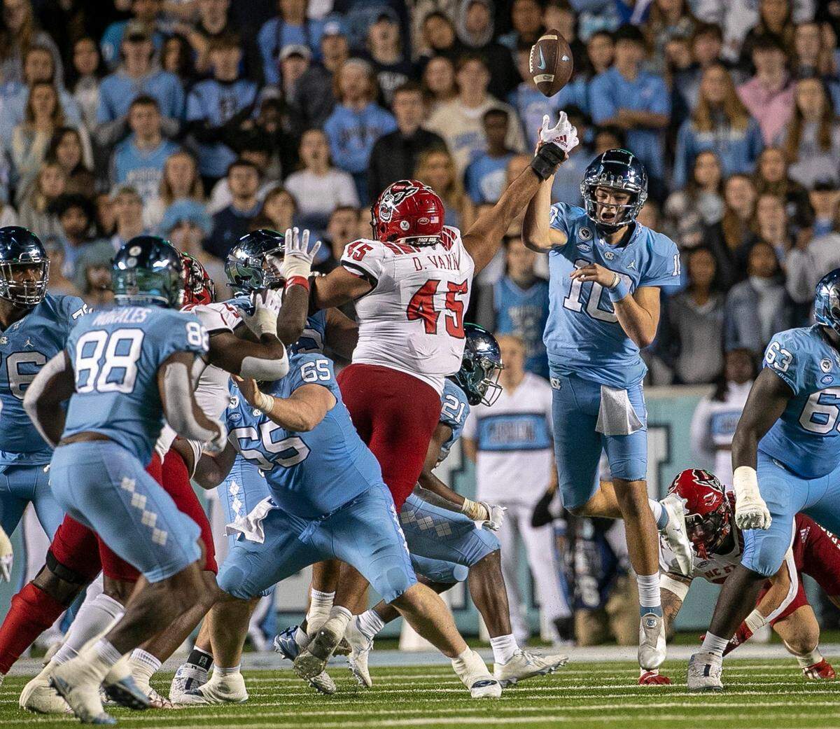 N.C. State’s Davin Vann (45) gets his hand on a pass attempt by North Carolina quarterback Drake Maye, tipping the ball, which was intercepted by Tanner Ingle in the fourth quarter on Friday, November 25, 2022 at Kenan Stadium in Chapel Hill, N.C.