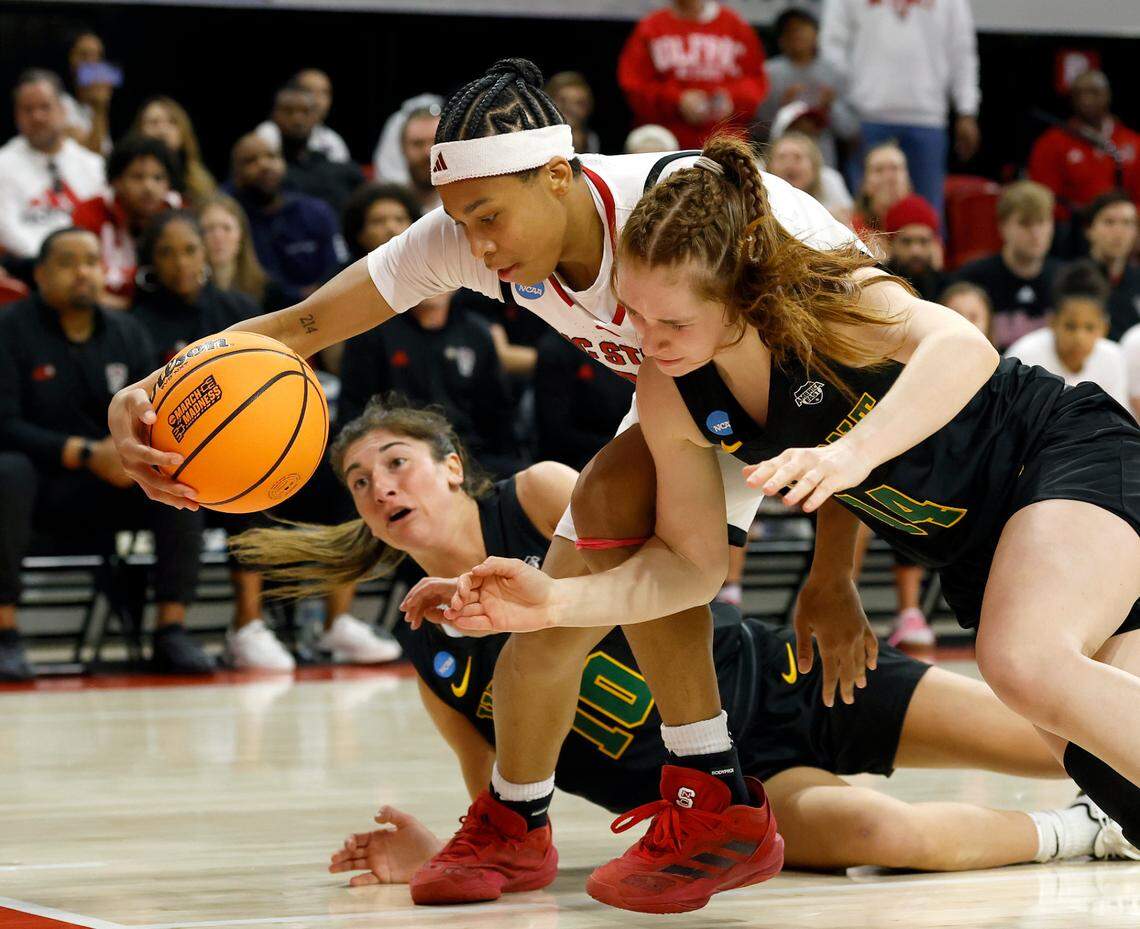 Vermont’s Bella Vito and Catherine Gilwee pressure N.C. State’s Zoe Brooks during the second half of the Wolfpack’s 75-55 win in the first round of the NCAA Tournament on Saturday, March 22, 2025, at Reynolds Coliseum in Raleigh, N.C.
