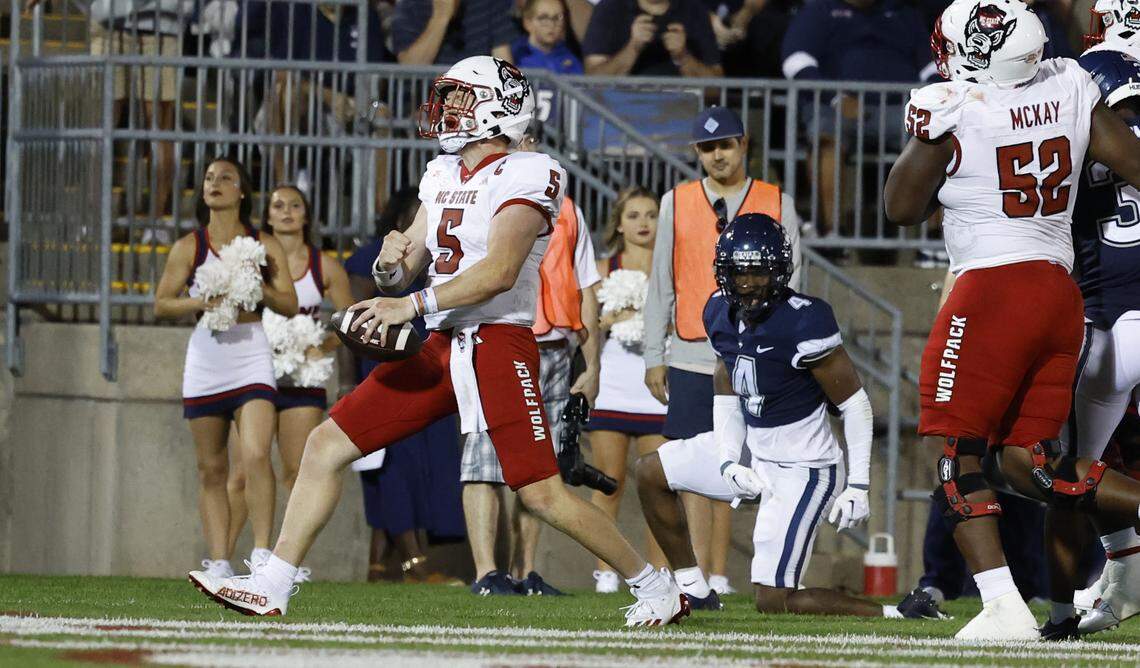 N.C. State quarterback Brennan Armstrong (5) celebrates after scoring on a 8-yard touchdown run during the second half of N.C. State’s 24-14 victory over UConn at Rentschler Field in East Hartford, Conn. Thursday, August 31, 2023.