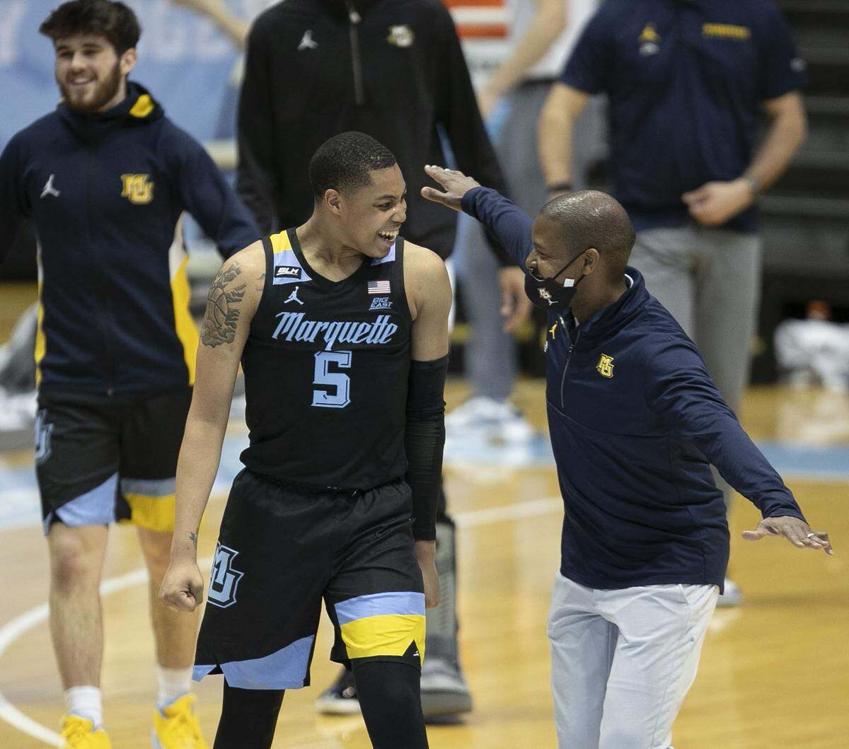 Marquette associate head coach Justin Gainey assistant celebrates with Greg Elliott (5) after defeating North Carolina 83-70 on Wednesday, February 24, 2021 at the Smith Center in Chapel Hill, N.C.