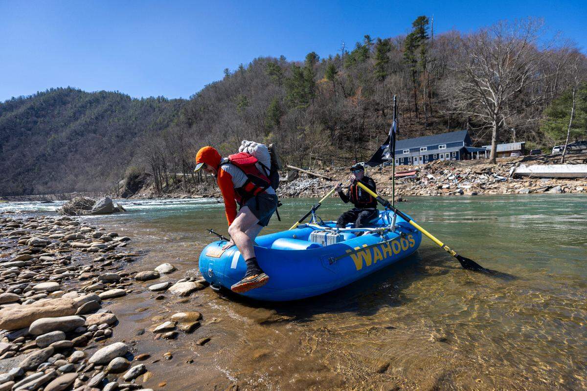 Mike Crooks ferries an Appalachian Trail hiker known as “Tree Stand” across the Nolichucky River near the former site of the Chestoa Pike Bridge in Erwin, Tennessee.