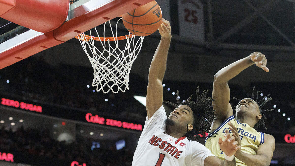N.C. State’s Jayden Taylor is fouled as he drives to the basket past Georgia Tech’s Tafara Gapare during the second half of the Wolfpack’s 82-76 win on Saturday, Feb. 3, 2024, at PNC Arena in Raleigh, N.C.