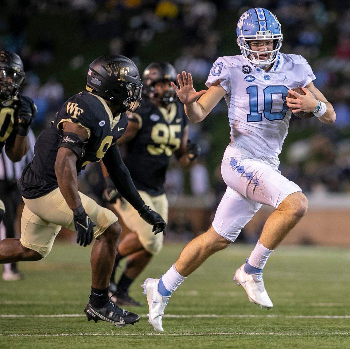 North Carolina quarterback Drake Maye (10) picks up ten yards in the third quarter against Wake Forest on Saturday, November 12, 2022 at Truist Field in Winston-Salem, N.C.